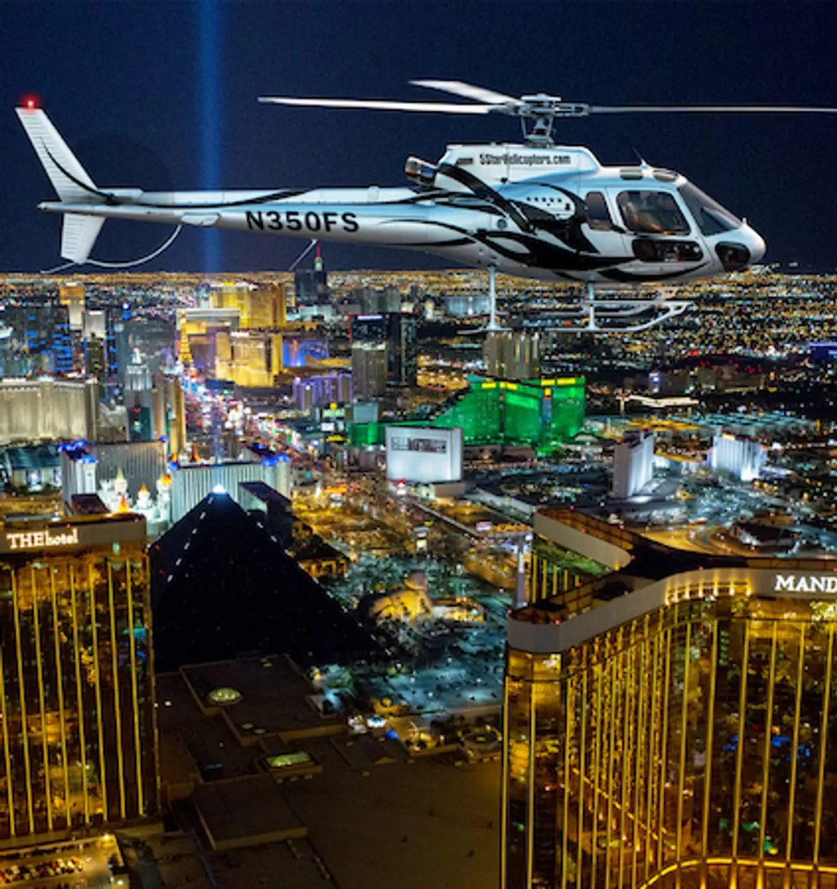 Helicopter over the lit Las Vegas Strip at night